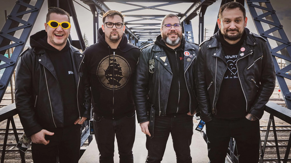 Promotional photo of Teenage Bottlerocket standing on a steel railway bridge